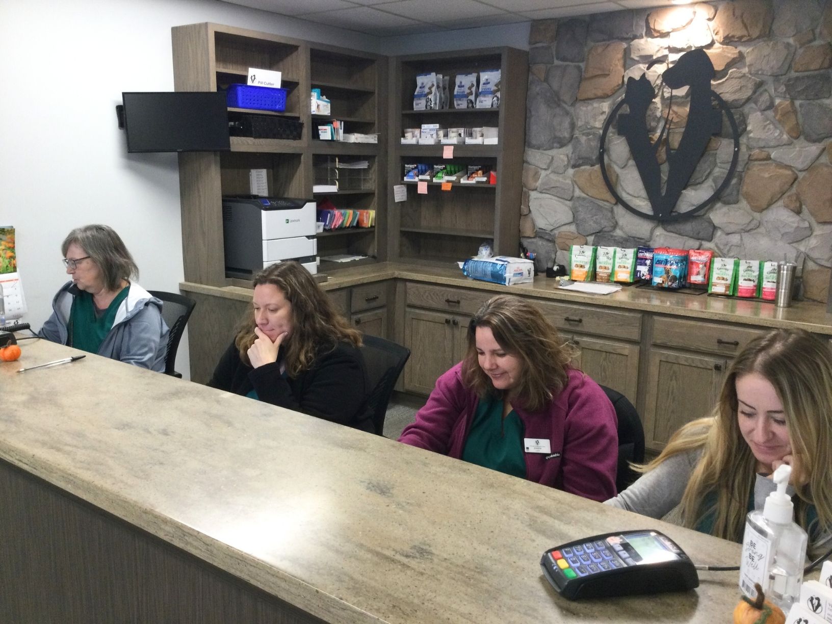 Four receptionists working in the front desk